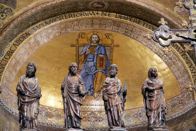 Christ enthroned in the gold mosaic of the main apse, above a row of four statues