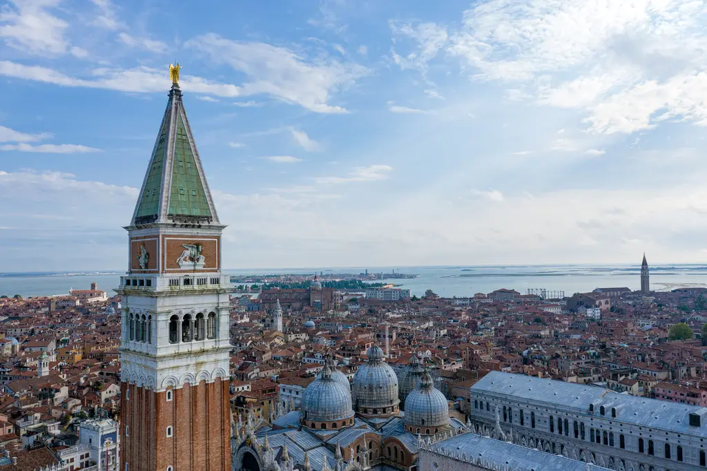 The Campanile seen from above, with the Basilica’s domes at its foot and the lagoon beyond