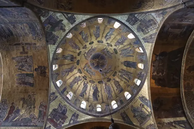 A mosaic dome inside St Mark’s seen from below, ringed by windows and gold-ground figures