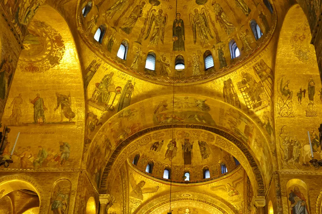 Gold mosaics covering the domes and arches inside St Mark’s, lit from within