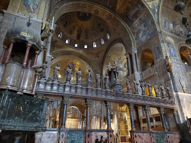 Inside St Mark’s looking east: the iconostasis with its statues, a pulpit on the left and the domes above