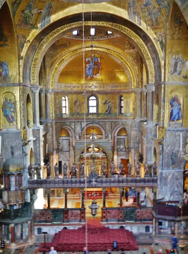 The presbytery seen down the nave, framed by gold mosaic arches