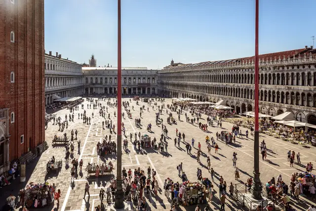 Piazza San Marco seen from the Basilica’s terrace, between the flagpoles, with the Procuratie on both sides